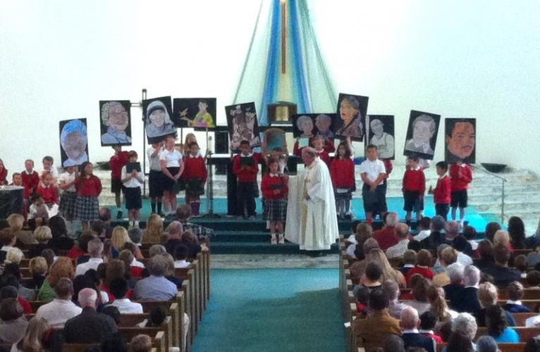 Third grade teaching us how to be difference makers at our Grandparents Day Mass